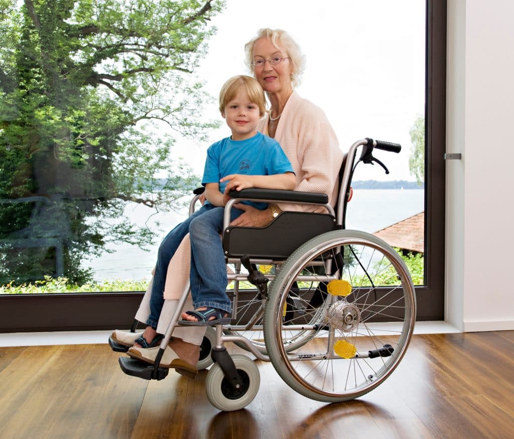 boy sitting on senior woman's lap